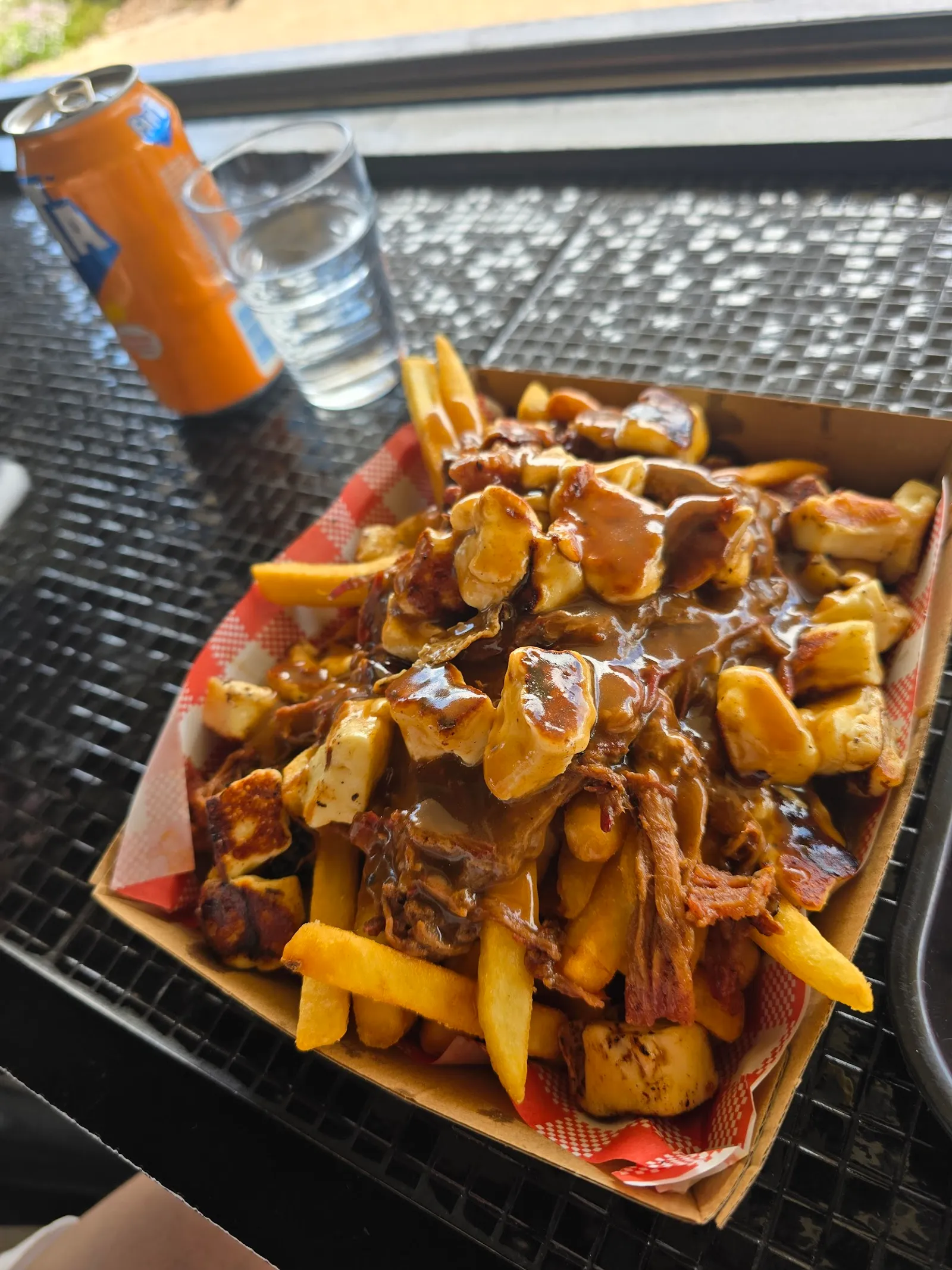 Loaded poutine with pulled pork, gravy and cheese in a takeaway box at The Corner